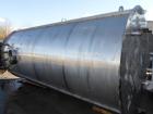 Used 6000 Gallon Stainless Steel Storage Tank. Approximately 94'' diameter, 16' straight wall, side manhole.  Inlets 3-1.5'' threaded 2-3''. Outlets 3'' bolt flange. Tank has large dent in top.