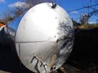 Used 6000 Gallon Stainless Steel Storage Tank. Approximately 94'' diameter, 16' straight wall, side manhole.  Inlets 3-1.5'' threaded 2-3''. Outlets 3'' bolt flange. Tank has large dent in top.