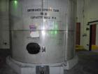 Used Saracco Tank & Mfg Approximately 10,000 Gallon Stainless Steel Storage Tank. Approximately 12' diameter x 12' straight side. Flat bottom and slight cone top. Various top openings including a 17