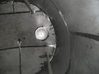Used Saracco Tank & Mfg Approximately 5,200 Gallon Stainless Steel Storage Tank. Approximately 9' diameter x 11' straight side. Flat bottom and slight cone top. Various top openings including a 17