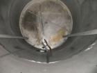 Used Saracco Tank & Mfg Approximately 5,200 Gallon Stainless Steel Storage Tank. Approximately 9' diameter x 11' straight side. Flat bottom and slight cone top. Various top openings including a 17