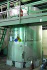 Used Krenz Approximately 5,200 Gallon Stainless Steel Storage Tank. Approximately 9' diameter x 11' straight side. Flat bottom and slight cone top. Various top openings including a 17