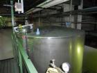 Used Krenz Approximately 5,200 Gallon Stainless Steel Storage Tank. Approximately 9' diameter x 11' straight side. Flat bottom and slight cone top. Various top openings including a 17