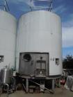Used 7,200 Gallon Stainless Steel Tank. Approximately 14' tall (with stands approximately 17'), 10' diameter, 2 x 4ft. jackets for glycol / coolant. Cooling channels built into floor. Inverted cone f...
