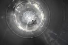Used Tank, Approximate 19,500 Gallon, 14 Gauge Stainless steel, Vertical. Approximate 130” diameter x 336” straight side, coned top, 7” sloped bottom. Openings top 16” man way with cover and approxim...