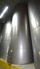Used Tank, Approximate 19,500 Gallon, 14 Gauge Stainless steel, Vertical. Approximate 130” diameter x 336” straight side, coned top, 7” sloped bottom. Openings top 16” man way with cover and approxim...