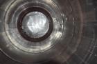 Used Tank, Approximate 19,500 Gallon, 14 Gauge Stainless steel, Vertical. Approximate 130” diameter x 336” straight side, coned top, 7” sloped bottom. Openings top 16” man way with cover and approxim...