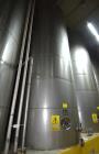 Used Tank, Approximate 19,500 Gallon, 14 Gauge Stainless steel, Vertical. Approximate 130” diameter x 336” straight side, coned top, 7” sloped bottom. Openings top 16” man way with cover and approxim...