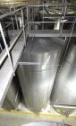 Used Tank, Approximate 19,500 Gallon, 14 Gauge Stainless steel, Vertical. Approximate 130” diameter x 336” straight side, coned top, 7” sloped bottom. Openings top 16” man way with cover and approxim...