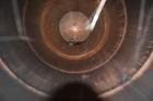Used Tank, Approximate 19,500 Gallon, 14 Gauge Stainless steel, Vertical. Approximate 130” diameter x 336” straight side, coned top, 7” sloped bottom. Openings top 16” man way with cover and approxim...