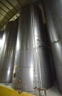Used Tank, Approximate 19,500 Gallon, 14 Gauge Stainless steel, Vertical. Approximate 130” diameter x 336” straight side, coned top, 7” sloped bottom. Openings top 16” man way with cover and approxim...