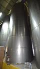 Used Tank, Approximate 19,500 Gallon, 14 Gauge Stainless steel, Vertical. Approximate 130” diameter x 336” straight side, coned top, 7” sloped bottom. Openings top 16” man way with cover and approxim...