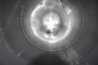 Used Tank, Approximate 19,500 Gallon, 14 Gauge Stainless steel, Vertical. Approximate 130” diameter x 336” straight side, coned top, 7” sloped bottom. Openings top 16” man way with cover and approxim...