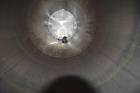 Used Tank, Approximate 19,500 Gallon, 14 Gauge Stainless steel, Vertical. Approximate 130” diameter x 336” straight side, coned top, 7” sloped bottom. Openings top 16” man way with cover and approxim...