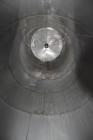 Used Tank, Approximate 19,500 Gallon, 14 Gauge Stainless steel, Vertical. Approximate 130” diameter x 336” straight side, coned top, 7” sloped bottom. Openings top 16” man way with cover and approxim...