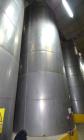 Used Tank, Approximate 19,500 Gallon, 14 Gauge Stainless steel, Vertical. Approximate 130” diameter x 336” straight side, coned top, 7” sloped bottom. Openings top 16” man way with cover and approxim...