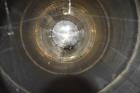 Used Tank, Approximate 19,500 Gallon, 14 Gauge Stainless steel, Vertical. Approximate 130” diameter x 336” straight side, coned top, 7” sloped bottom. Openings top 16” man way with cover and approxim...