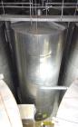 Used Tank, Approximate 19,500 Gallon, 14 Gauge Stainless steel, Vertical. Approximate 130” diameter x 336” straight side, coned top, 7” sloped bottom. Openings top 16” man way with cover and approxim...