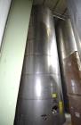 Used Tank, Approximate 19,500 Gallon, 14 Gauge Stainless steel, Vertical. Approximate 130” diameter x 336” straight side, coned top, 7” sloped bottom. Openings top 16” man way with cover and approxim...