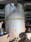 Used 7,600 Gallon Vertical Stainless Steel Tank. 316L Stainless steel. Approximately 10' diameter x 13' tall. Side manway. Side bottom outlet.