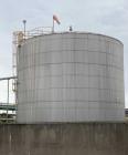 Used Approximate 216,000 gallons Stainless Steel Storage Tank With Philadelphia 40 HP Side Mount Agitator. T-1010. Flat top and Bottom. Misc. inlets Side bottom. Side Bottom Manway.