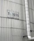 Used Approximate 216,000 gallons Stainless Steel Storage Tank With Philadelphia 40 HP Side Mount Agitator. T-1010. Flat top and Bottom. Misc. inlets Side bottom. Side Bottom Manway.
