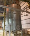 Used Approximate 9000 gallon Stainless Steel Storage Tank With 5 HP Centrifugal Pump, V-4780. approximate 120' X 15' T/T. Misc. top inlets. Cone bottom with center bottom outlet. Bottom side manway. ...