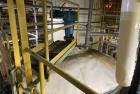 Used Approximate 8000 gallon Stainless Steel Mixing Tank With Centrifugal Pump, V-4506. Flat top with misc. top inlets. Cone bottom with center bottom outlet. Insulated shell. Top entering Chemineer ...