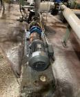 Used Approximate 8000 gallon Stainless Steel Mixing Tank With Centrifugal Pump, V-4506. Flat top with misc. top inlets. Cone bottom with center bottom outlet. Insulated shell. Top entering Chemineer ...