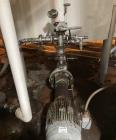 Used Approximate 5200 gallon Stainless Steel Mixing Tank. 12C. Includes centrifugal pump.