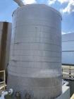 approximately 9000 gallon stainless steel vertical storage tank.