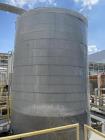 approximately 9000 gallon stainless steel vertical storage tank.