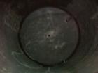 USED: Approximate 14,000 gallon stainless steel storage tank. Vertical, dished heads, 5' skirt bottom. 11'6
