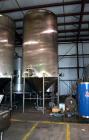 Used Apache Tank, 6500 Gallon, 316 Stainless Steel, Vertical. Approximate 102” diameter x 172” straight side. Dished top, 70” coned bottom. Side entering agitator with a 3 blade prop, driven by a 3hp...
