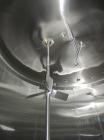 Used Cherry Burrell 8000 Gallon Vertical Stainless Steel Tank.Top mounted agitator, dual impeller, bearing block, side manway, sightglass, 3