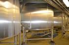 Used- Crepaco 6,000 Gallon (Approximately) Stainless Steel Vertical Single Wall Tank. Dome top, dished bottom center. Bridge...