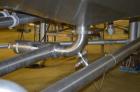Used Crepaco 6,000 Gallon (Approximately) Vertical Stainless Steel Single Wall Tank. Dome top, dished bottom center. Bridge mounted agitator. 10 hp motor. Sweep agitator. Internal baffles. Spray ball...