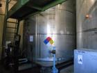 Used Krenz Approximately 10,000 Gallon Stainless Steel Storage Tank. Approximately 12' diameter x 12' straight side. Flat bottom and slight cone top. Various top openings including a 17