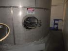 Used Krenz Approximately 10,000 Gallon Stainless Steel Storage Tank. Approximately 12' diameter x 12' straight side. Flat bottom and slight cone top. Various top openings including a 17