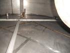 Used Krenz Approximately 10,000 Gallon Stainless Steel Storage Tank. Approximately 12' diameter x 12' straight side. Flat bottom and slight cone top. Various top openings including a 17