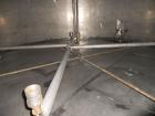 Used Krenz approx. 10,000 gallon stainless steel storage tank. Approx. 12' diameter x 12' straight side. Flat bottom and slight cone top. Various top openings including a 17