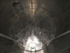 Used Krenz approx. 10,000 gallon stainless steel storage tank. Approx. 12' diameter x 12' straight side. Flat bottom and slight cone top. Various top openings including a 17