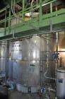 Used Krenz Approximately 8,500 Gallon Stainless Steel Storage Tank. Approximately 11' diameter x 12' straight side. Flat bottom and slight cone top. Various top openings including a 17