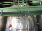 Used Krenz Approximately 8,500 Gallon Stainless Steel Storage Tank. Approximately 11' diameter x 12' straight side. Flat bottom and slight cone top. Various top openings including a 17