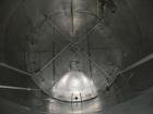 Used Krenz Approximately 8,500 Gallon Stainless Steel Storage Tank. Approximately 11' diameter x 12' straight side. Flat bottom and slight cone top. Various top openings including a 17
