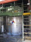 Used Krenz Approximately 8,500 Gallon Stainless Steel Storage Tank. Approximately 11' diameter x 12' straight side. Flat bottom and slight cone top. Various top openings including a 17