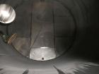Used Krenz Approximately 10,000 Gallon Stainless Steel Storage Tank. Approximately 12' diameter x 12' straight side. Flat bottom and slight cone top. Various top openings including a 17