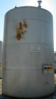 USED: Metal Equipment tank, approximately 6,760 gallon, stainless steel. Approximate 9' diameter x 14' straight side. Misc top openings. 2