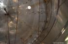 Used Tank, Approximate 22,900 Gallon, 304 Stainless Steel, Vertical. Approximate 148” diameter x 308” straight side, coned top, flat bottom. Openings top 2”, 6”, 9” hand hole with cover. Side bottom ...