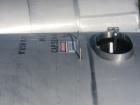 Used Saracco Tank & Mfg Approximately 5,200 Gallon Stainless Steel Storage Tank. Approximately 9' diameter x 11' straight side. Flat bottom and slight cone top. Various top openings including a 17